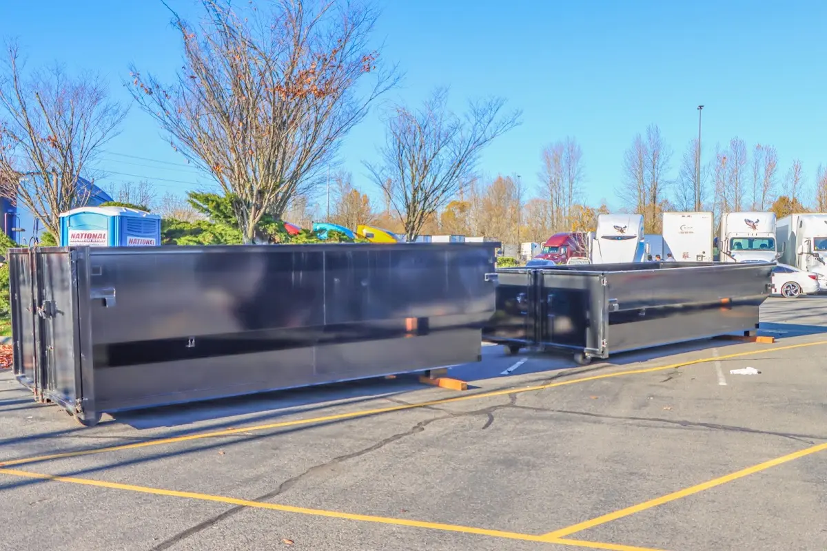 Professional dumpster rental service with roll-off container on residential driveway in Missouri City